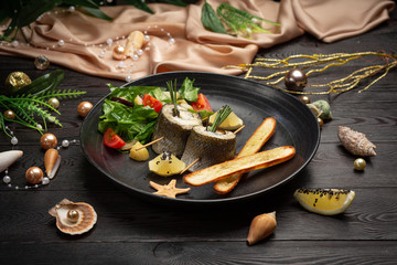 Baked seabass with eggplant, mozzarella cheese, with fresh salad and grissini sticks