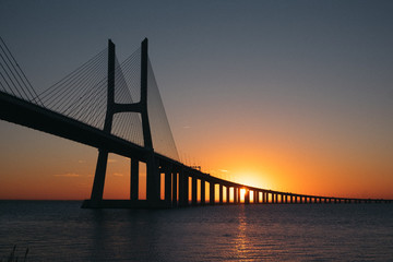 Vasco da Gama Bridge at sunrise in Lisbon, Portugal. Second longest bridge in Europe.