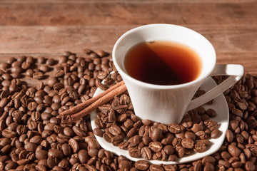 White coffee cup  and coffee beans  on wood table