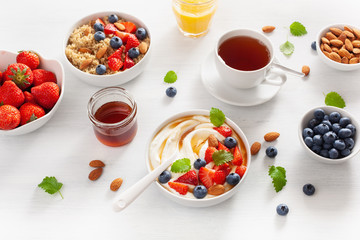 yogurt with strawberry blueberry honey almond and quinoa for breakfast