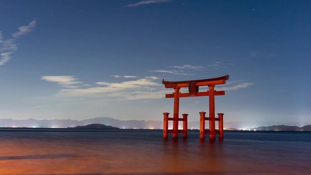 Lake Biwa at night with torii gate and starry sky