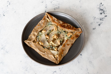 Galette bretonne with pear and gorgonzola cheese. Is a large buckwheat crepe that is stuffed with various savory fillings.