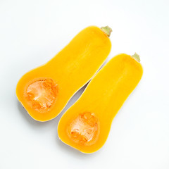 Two slices of half pumpkin against a white background. Autumn harvest..Ingredients for diet salad or freshly squeezed juice.
