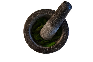 stone mortar and pestle with mint leaves
