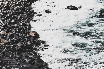 Black beach with wave