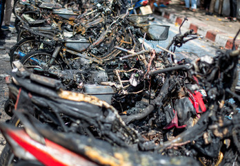 Terrorists set fire to motorbikes on a street in the city.