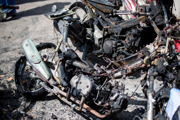 Terrorists set fire to motorbikes on a street in the city.