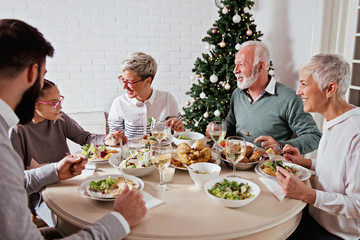 Family gathered over for Christmas holidays, celebrating, having lunch 