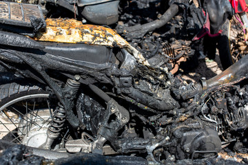 Terrorists set fire to motorbikes on a street in the city.