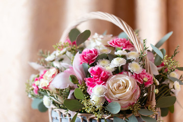 Close up of pink flower arrangement. Rose, Dianthus, Alstroemeria, Chrysanthemum. Bouquet of spring flowers in basket.