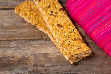Mexican amaranth bar with peanuts and honey also called "alegria" on wooden background