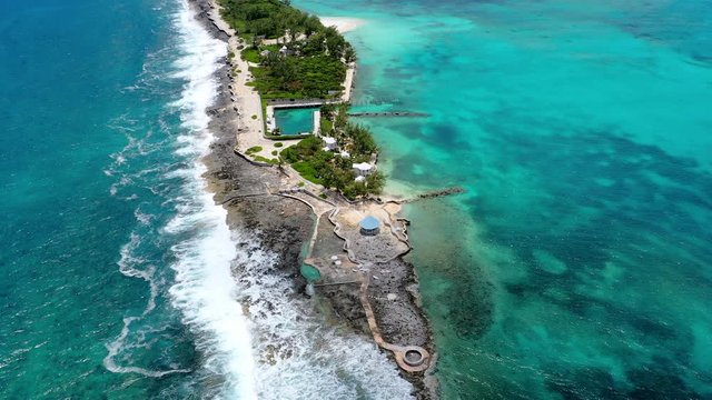 Aerial: Waves Crashing Onto Secluded Tropical Peninsula Surrounded By Lovely Blue Water - Nassau, Bahamas
