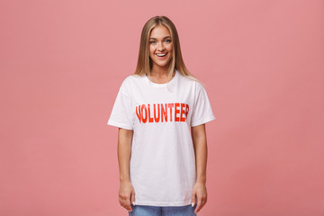 Happy young volunteer girl standing isolated