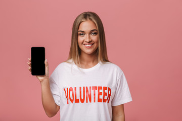 Happy young volunteer girl standing isolated