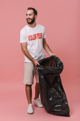 Full length portrait of a volunteer man holding rubbish bag