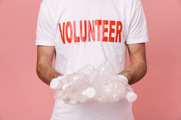 Close up of a man volunteer showing empty plastic bottles