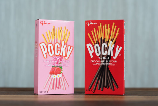 Petaling jaya, Selangor, Malaysia - 20 Oktober 2019 : Pocky brand of chocolate sticks on wooden table. Pocky is a famous confectionery among asian people