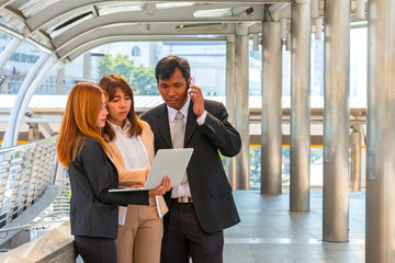 Businesspeople using laptop for consulting about his project wit