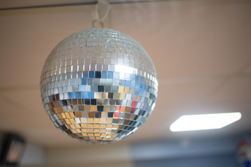 A disco ball rolling on the ceiling