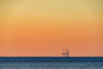 Foto auf Acrylglas old cargo ship at sunset © Nora