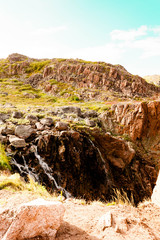 Beautiful summer day landscape waterfall North Teriberka, Barents sea view.