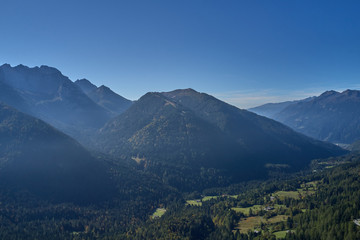 Obraz premium Autumn season, red-yellow trees. Aerial photography. Panoramic view of the Alps north of Italy. Trento Region. Great trip to the Alps.