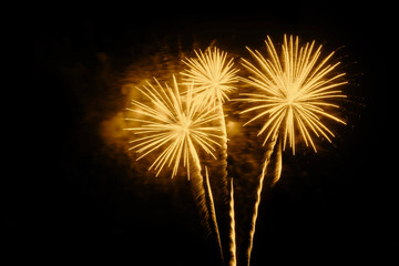 Golden fireworks on a black background