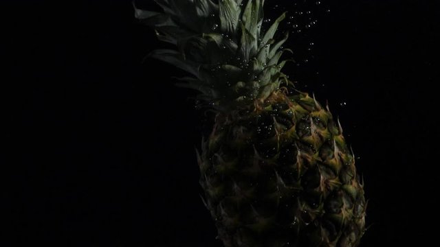 pineapple falls into the water with bubbles, slomotion 180fps