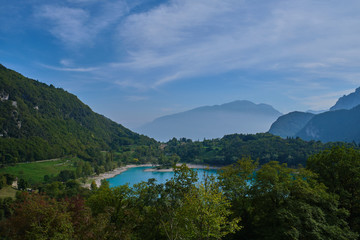 Fototapeta na wymiar Turquoise color Lake Tenno Italy surrounded by Alpine mountains