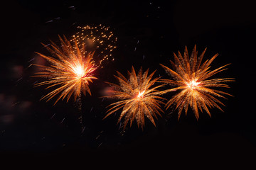 Three fireworks on a black background.