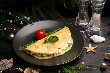 Chinese onion tortilla with cottage cheese and herbs in a black plate