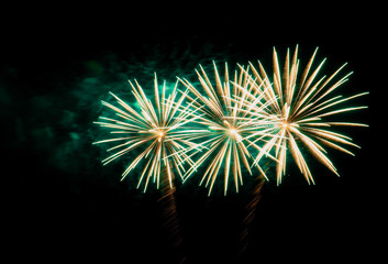 Firework with green smoke on a black background.