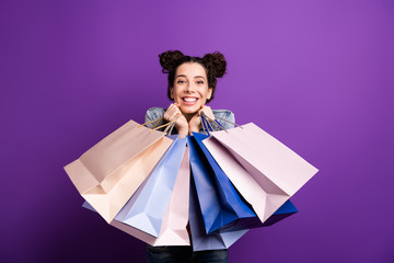 Portrait of positive cheerful girl have fun on shopping hold many bags packages feel content...