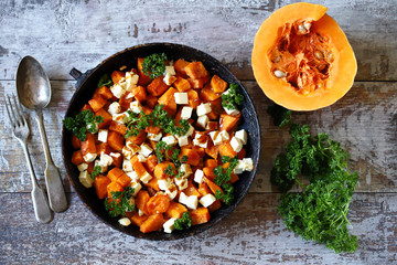 Salad with baked pumpkin and feta. Thanksgiving salad. Autumn keto salad. Keto diet. Selective focus. Macro.