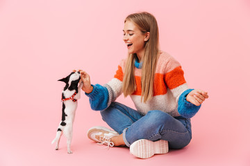 Happy lovely girl playing with her pet chihuahua