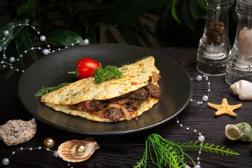 Chinese onion tortilla with beef and onions in a black plate