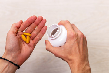 man hand holding drug medicine bottle on Herbal supplement pill,eating healthy