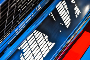 Bold red, chrome and black abstract of a 60s muscle car grille.