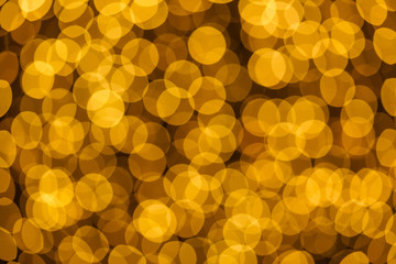 Christmas and New Year golden yellow background with abstract blurred highlights. Bokeh in blur.