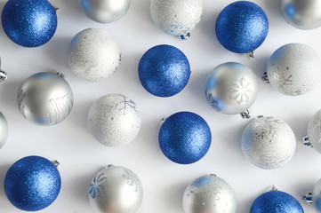Grey and blue Christmas balls on white background. Preparation for the New year and Christmas. holiday decor. Waiting for the holiday.