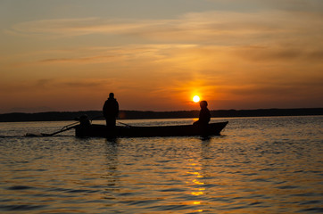 Naklejka na ściany i meble The fisherman and boat silhouette
