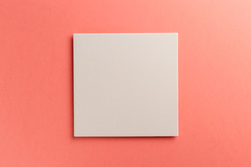 Creative layout made of paper blank on pastel on coral background. Top view. Flat lay. Copy space....