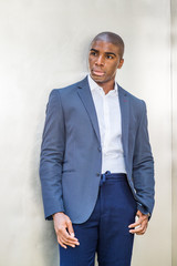 Portrait of Young African American Man in New York City. Wearing blue blazer, white shirt, blue...