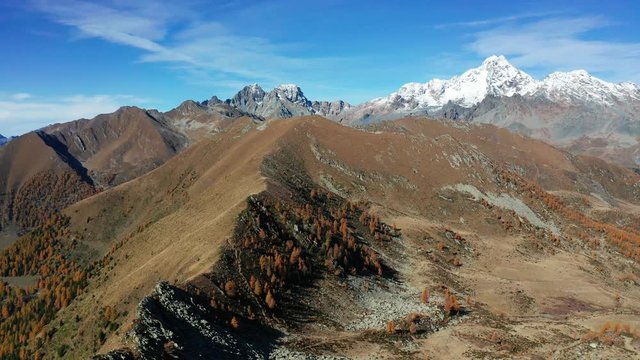 Aerial 4K - Valtellina (IT) - Autumnal view of Mount Disgrazia and Peak Badile from the Arcoglio alp 