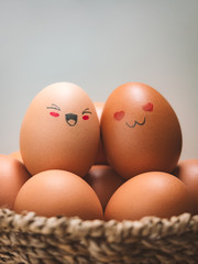 Egg lovers have happy faces of men and women on the pile of eggs in the basket with copy space. Organic egg food ingredients, Couples, Easter, Valentine's day concept.