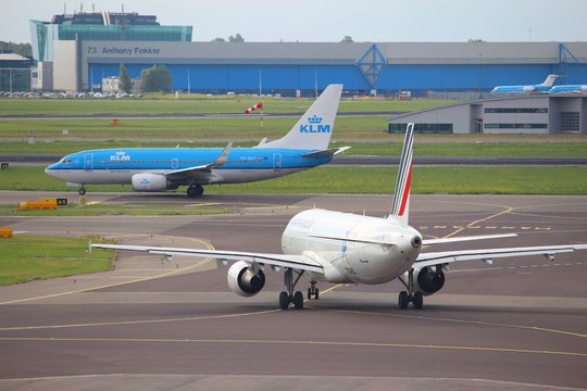 AMSTERDAM, NETHERLANDS - JULY 11, 2017: Air France and KLM aircraft at Schiphol Airport in Amsterdam. Schiphol is the 12th busiest airport in the world with more than 63 million annual passengers.