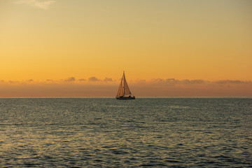 Sailboat sailing at dawn in Alcocebre