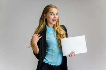 Naklejka premium Portrait of a pretty blonde girl financial secretary with long curly hair in a business suit standing in the studio on a white background with emotions in different poses with a folder in his hands.