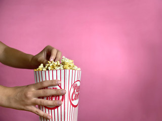 Girl is holding popcorn and eating it