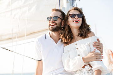 Optimistic cheery young loving couple outdoors